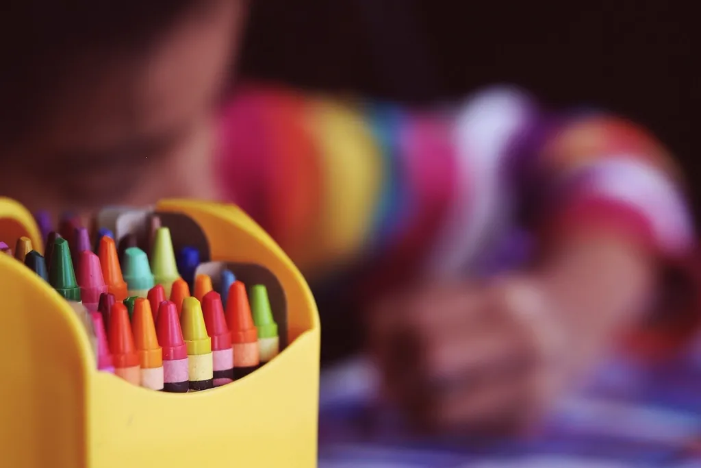 A box of bright crayons at a children’s table